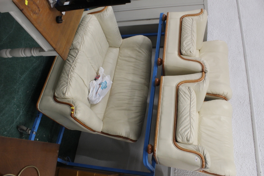A cream leather three piece suite with w