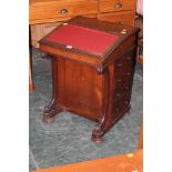 A Victorian walnut davenport with leathe