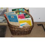 A wicker basket of mixed ordnance survey and other maps.