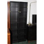 A pair of black Ikea bookcases