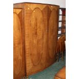 A walnut or mahogany bowfronted wardrobe