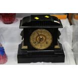 Late 19th/early 20 the century mantle clock with black metal body and gilt face