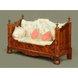 A large 19th century walnut daybed, with deep buttoned upholstered back and loose cushions,