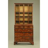 An antique walnut cabinet on chest,