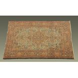 An antique Hamadan rug, with centre rectangular panel and repeating line border,