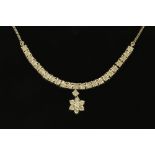 A silver illusion set diamond necklace with star pendant and chain.