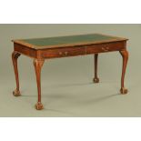 An early 20th century mahogany writing table, with green tooled leather writing surface,