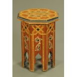 An Islamic octagonal occasional table with painted and inlaid decoration.