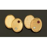 A pair of 9 ct gold cufflinks with chain connections, four engine turned oval plates,