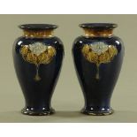 A pair of Royal Doulton blue ground vases in the Art Nouveau style, with impressed marks to base.