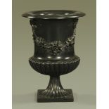 A composition garden urn, campana shaped with moulded ribbon and swags.