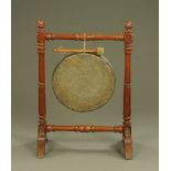 A Victorian pine framed dinner gong, with turned supports and downswept legs.