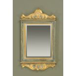 A gilt and grey painted wall mirror, with bevelled glass. Height 103 cm, width 64 cm.