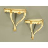 A pair of cream and gilt painted shaped pier tables, with scroll supports. Width 63.