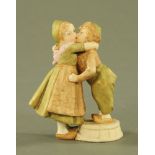 A Royal Dux figure group Dutch children kissing, pink triangle mark to base and faintly impressed.