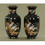 A pair of oriental style vases, with blue ground decorated with cranes. Height 37 cm.