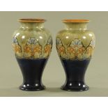 A pair of Royal Doulton Art Nouveau blue and green ground vases,