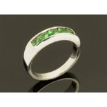 An 18 ct white gold demantoid half eternity ring, Size M/N.