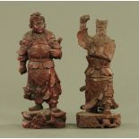 Two Chinese stained and carved wood figures of warriors, each 33 cm high.