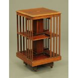 An Edwardian inlaid mahogany square revolving bookcase,