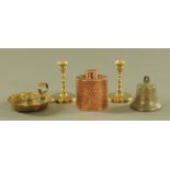 An antique bronze bell, together with a pair of brass candlesticks, chamber stick and copper caddy.