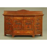 An Art Nouveau oak sideboard, with rear upstand, canted angles,