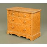 A late Victorian painted satinwood effect pine chest of drawers, with ebonised stringing,