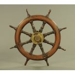 A large 19th century ships wheel, with brass centre. Width 90 cm.