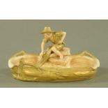 A Royal Dux shallow bowl with seated boy fisherman, pink triangular mark to base. Length 33 cm.
