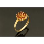 A 9 ct gold garnet set cluster ring, Size K.