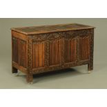 An early 20th century carved oak coffer, with linenfold panels.