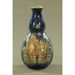 A Della Robbia gourd shaped vase, decorated with ships against a blue ground, incised marks to base.
