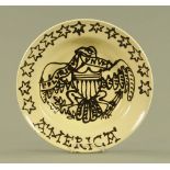 A large cream glazed and black slip trailed stoneware charger, "America", 44 cm diameter,