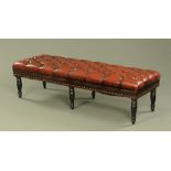 A large Victorian style faux leather upholstered window seat,