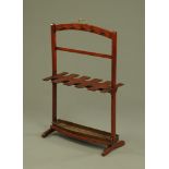 A 19th century mahogany boot and whip rack, with drip tray and carrying handle.