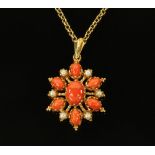 A gold coloured metal coral and seed pearl oval pendant, with 9 ct gold chain,