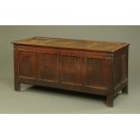 A large late 17th century oak coffer, with four panelled front and with inlay and carving to frieze,
