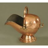 A Victorian copper coal helmet, with swing handle.