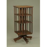 An oak square revolving bookcase, raised on short castors. Height 105 cm, width 45 cm.