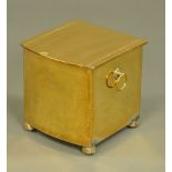 A brass bowfronted coal box, raised on short bun feet. Height 31 cm, width 30 cm, depth 31 cm.