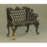 A Victorian cast iron garden bench, with lattice work back and angled wings,