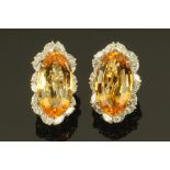 A pair of 18 ct gold citrine and diamond earrings, length 25 mm, width 12 mm (see illustration).