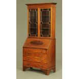 An Edwardian inlaid mahogany bureau bookcase, with moulded cornice above a pair of glazed doors,