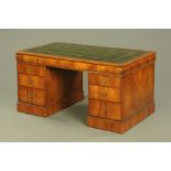 An early 20th century walnut pedestal desk,