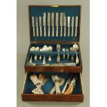 An oak canteen containing a quantity of silver plated cutlery,
