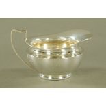 A George V silver cream jug by Daniel & John Wellby,
