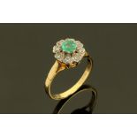 An 18 ct gold diamond cluster ring, with centre green stone, size L.