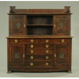 A late 19th/early 20th century Arts & Crafts oak sideboard,