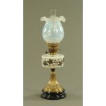 A Victorian oil lamp, with Vaseline glass shade painted reservoir brass and glass base beneath.