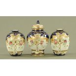 A garniture of three Noritake vases, painted with floral sprays and with gilding. Tallest 17 cm.